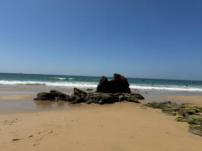 a pile of rocks sitting on the beach at Apartamentos Do Parque in Albufeira