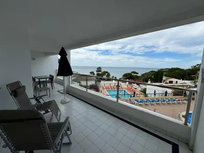 a balcony with a view of the beach and the ocean at Apartamentos Do Parque in Albufeira