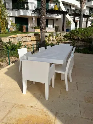 a patio with a table and chairs under a pergola at Vila Sol, Apartment 468 in Quarteira