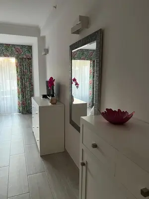 a room with a mirror and a bed and a table at Vila Sol, Apartment 468 in Quarteira