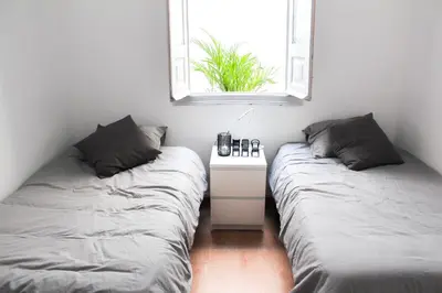 two beds sitting next to each other in a room at Atelier 3 - Boutique Rooms in Loulé