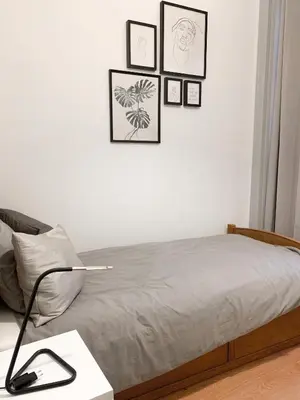 a bedroom with a bed with four pictures on the wall at Atelier 3 - Boutique Rooms in Loulé
