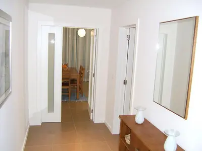 a hallway with a mirror and a table at Varandas de Carteia G/F in Quarteira