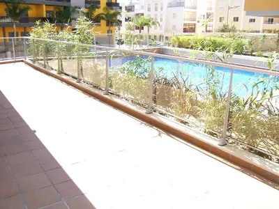 a swimming pool on the roof of a building at Varandas de Carteia G/F in Quarteira