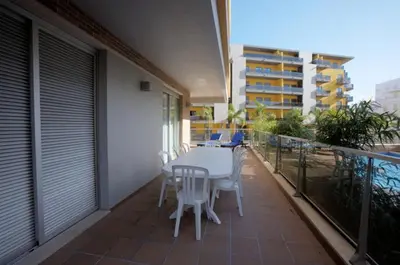 a patio with a table and chairs on a balcony at Varandas de Carteia G/F in Quarteira