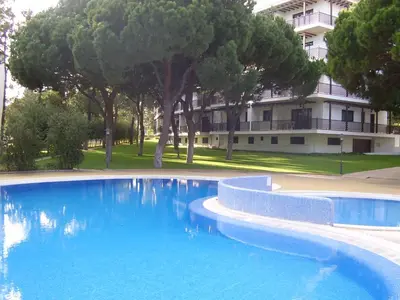 a large blue swimming pool in front of a building at Apartamento Falésia by Garvetur in Albufeira