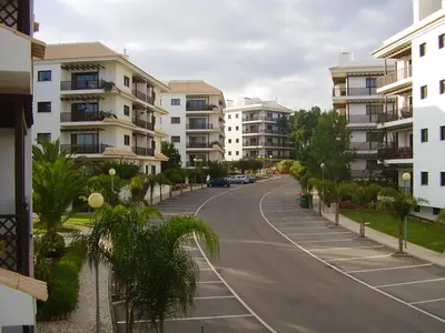 an empty street in a city with apartment buildings at Apartamento Falésia by Garvetur in Albufeira