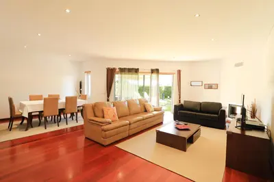 a living room with a couch and a table at Balaia Harmonia in Albufeira