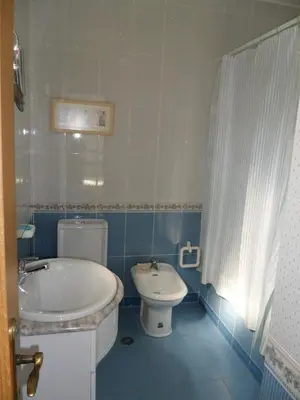 a bathroom with a tub and a toilet and a sink at Casa na praia e golfe in Vale do Lobo