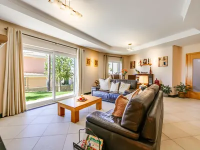 a living room with a couch and a table at Luxury Holiday Villa Alegria Galé Beach, Albufeira in Albufeira