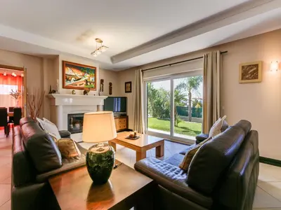 a living room with two leather couches and a fireplace at Luxury Holiday Villa Alegria Galé Beach, Albufeira in Albufeira