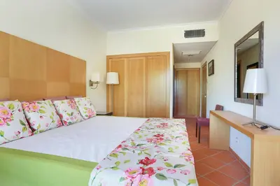 a hotel room with a bed and a desk at Golf F5 by Garvetur in Vilamoura