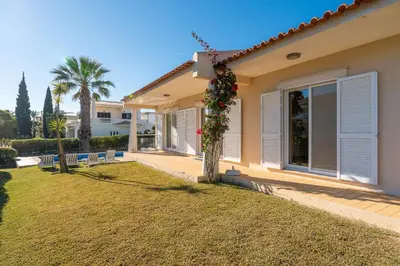 a house with a lawn in front of it at Villa Costa by Gabi Miguel in Albufeira