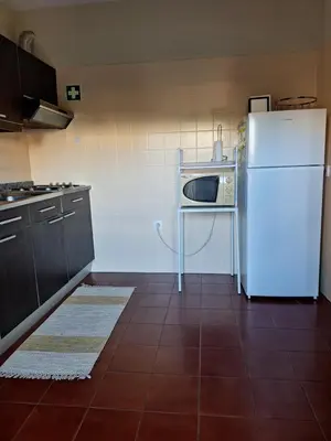 a large white building with a driveway in front of it at Apartament Olhos do Mar T1 beach Olhos de Água in Albufeira