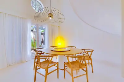 a dining room with a table and chairs at Pine Cliffs Village in Albufeira