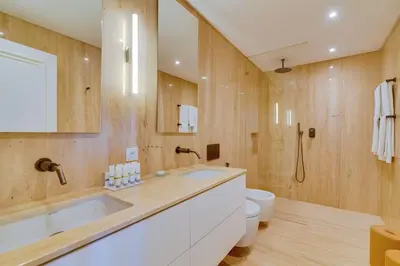 a bathroom with a large sink and a toilet at Pine Cliffs Village in Albufeira