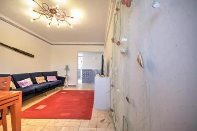 a living room with a couch and a red rug at In Faro with Sea View in Faro