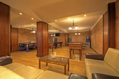 a restaurant with tables and chairs and a bar at Aparthotel Paladim & Alagoamar in Albufeira