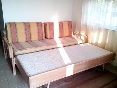 a bed sitting in the corner of a room at Charming Apartment in Albufeira, 60 m², Mountain View in Albufeira