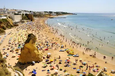 a crowd of people on a crowded beach at Charming Apartment in Albufeira, 60 m², Mountain View in Albufeira