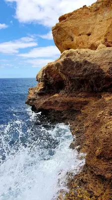 a rocky cliff next to the ocean at Albufeira Ocean Terrace (31) in Albufeira