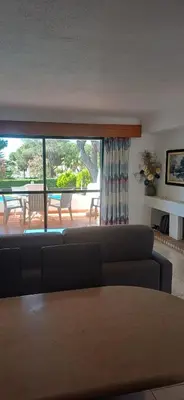 a living room with a couch and a table at Apartamento Solar dos Pinheiros in Vilamoura