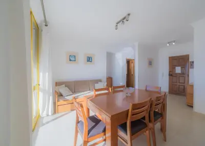 a balcony with chairs and a yellow door at Atlantida by Garvetur in Quarteira