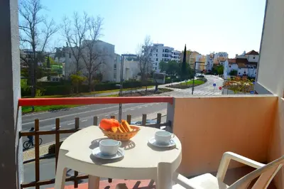 a table with a bowl of fruit on a balcony at Algardia Marina Parque by Garvetur in Vilamoura