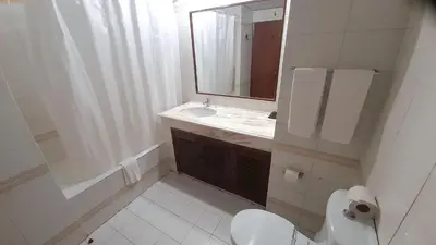 a bathroom with a toilet and a sink and a mirror at Algamar by Garvetur in Vilamoura