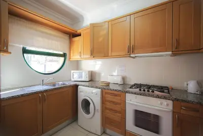 a kitchen with a washing machine and a sink at Eden Vilage by Garvetur in Vilamoura