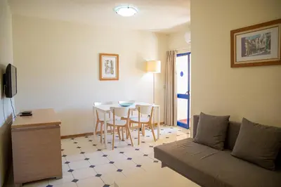 a living room with a couch and a table at Rio by Garvetur in Vilamoura