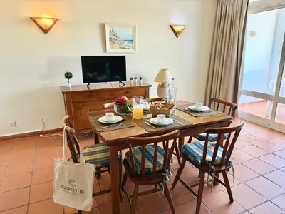 a bedroom with a bed and a table and chairs at Marina Plaza by Garvetur in Vilamoura