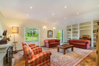 a living room with red furniture and a fireplace at Quinta das Figueiras - Bordeira - Faro in Bordeira