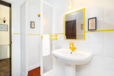 a white bathroom with a sink and a mirror at Quinta das Figueiras - Bordeira - Faro in Bordeira