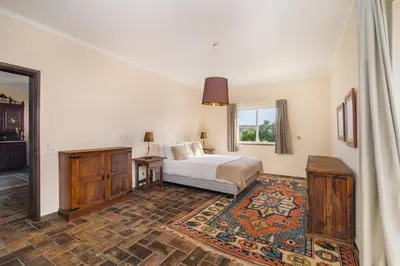 a bedroom with a bed and a window at Quinta das Figueiras - Bordeira - Faro in Bordeira