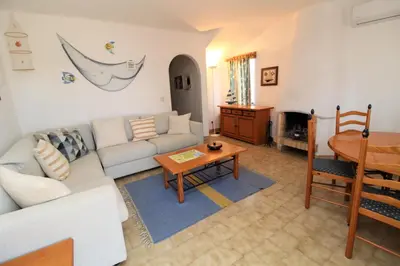a living room with a couch and a table at Apartamento 53A São Rafael T2 duplex - Albufeira, Algarve in Albufeira