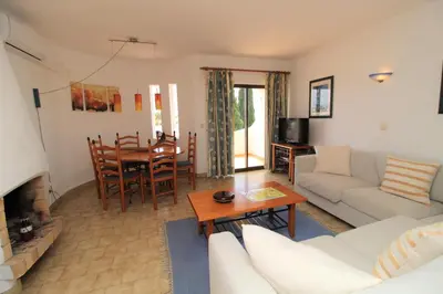 a living room with a couch and a table at Apartamento 53A São Rafael T2 duplex - Albufeira, Algarve in Albufeira