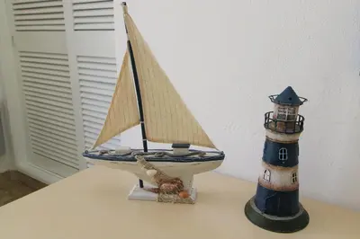 a toy boat and a lighthouse sitting on a table at Apartamento 53A São Rafael T2 duplex - Albufeira, Algarve in Albufeira