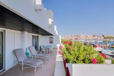 a balcony with chairs and a table and a harbor at São Vicente - 1Br - Facing to Marina in Quarteira
