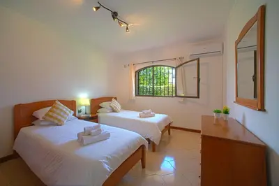 a bedroom with two beds and a window at 2 Bed Ground Floor Apartment In Vilamoura in Vilamoura