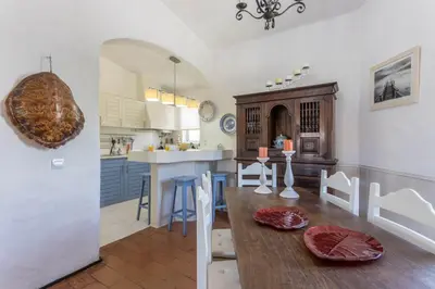 a kitchen and dining room with a wooden table at Villa Morena in Albufeira