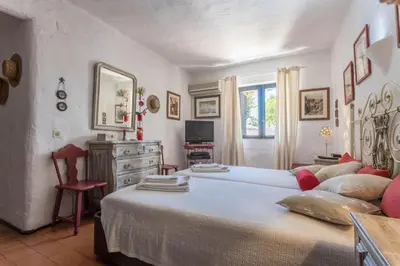 a bedroom with a large white bed with red pillows at Villa Morena in Albufeira