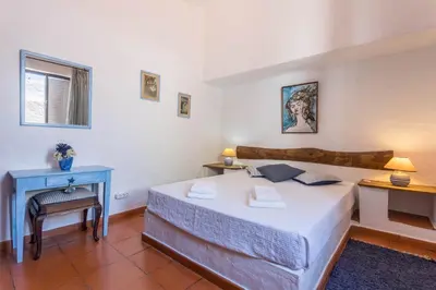 a bedroom with a bed and a blue table at Villa Morena in Albufeira