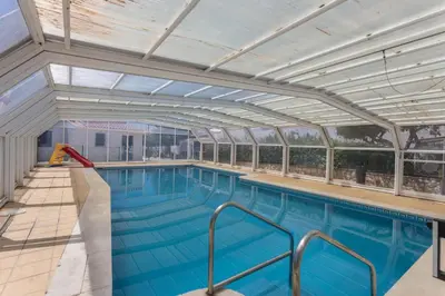 a large swimming pool with an open ceiling at Villa Morena in Albufeira