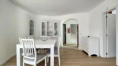 a white dining room with a white table and chairs at Villa Palmeira Galé Beach in Albufeira