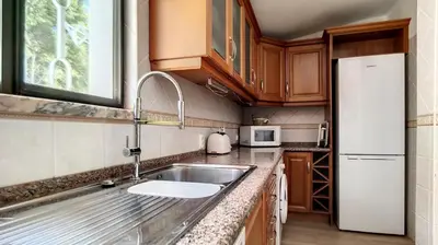 a kitchen with a sink and a refrigerator at Villa Palmeira Galé Beach in Albufeira