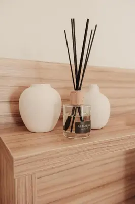 a table with three vases and a candle on it at Casa Velha Apartments - Adults friendly in Albufeira
