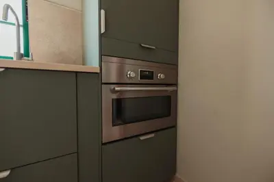 a kitchen with a stainless steel oven and cabinets at Casa Velha Apartments - Adults friendly in Albufeira