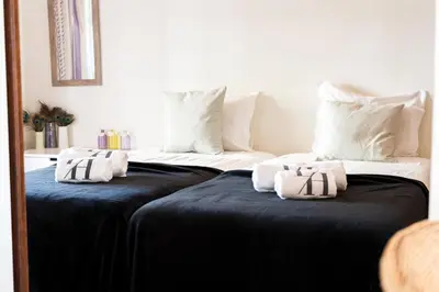 two beds with towels on them in a room at Old Village & Prestige in Vilamoura