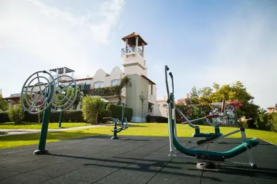 a gym in a park in front of a building at Old Village & Prestige in Vilamoura